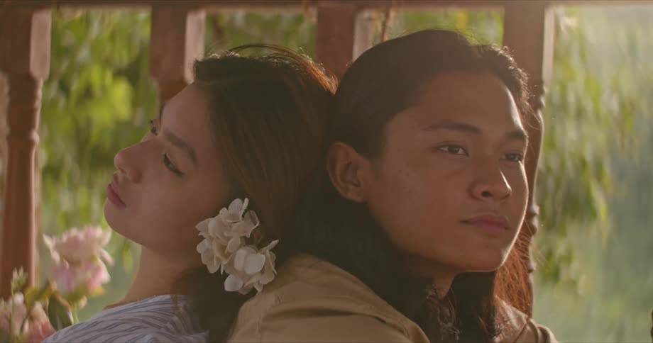 Young native american couple sitting near a wooden banister at morning resting against each other