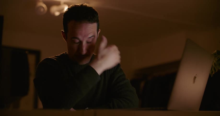 A man working on a laptop in a room