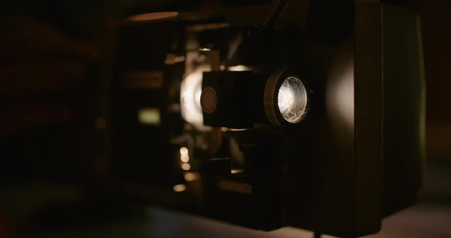 A person in a room touching a projector