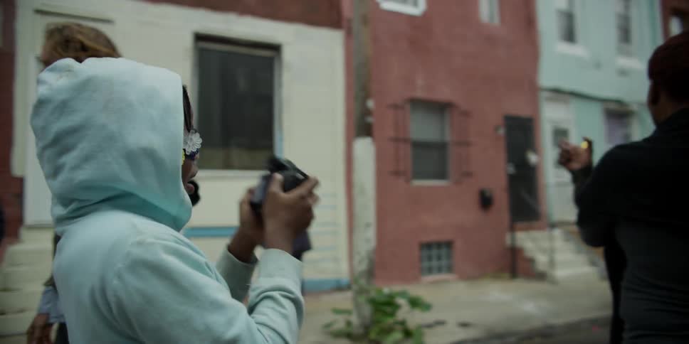 A girl in a blue jacket takes picture