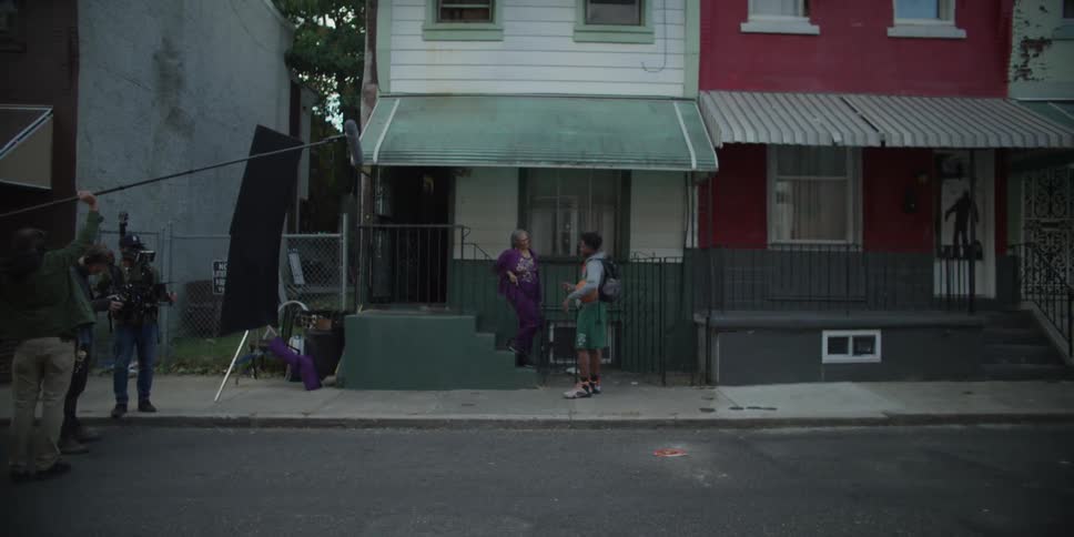 A man walks up to a home as he is being filmed
