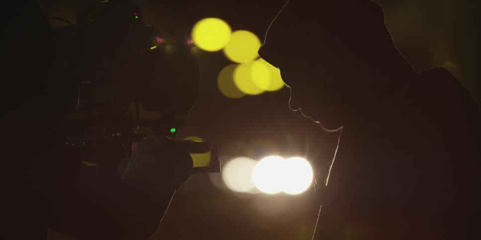 A man stands in front of a camera