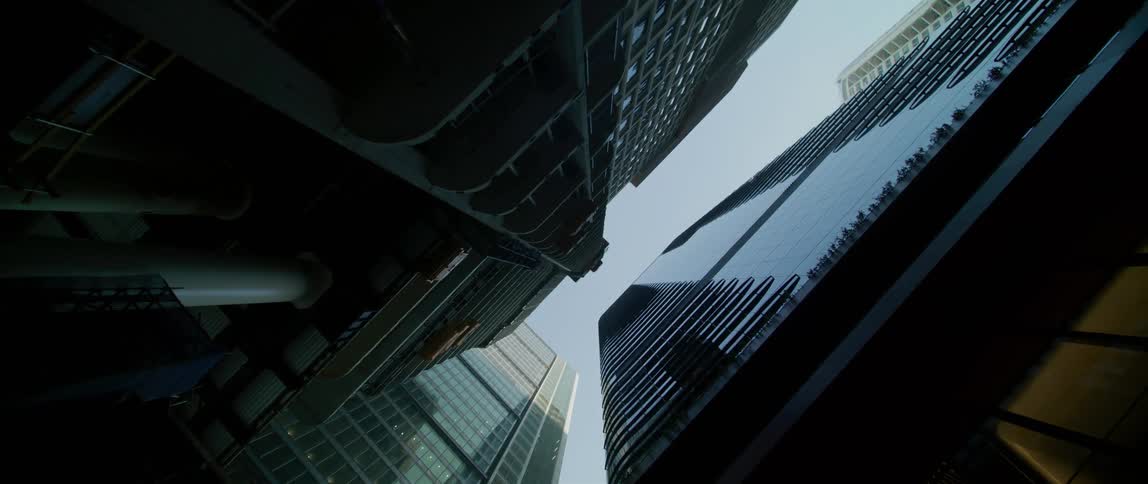 Tall skyscraper buildings in a city towering over the ground