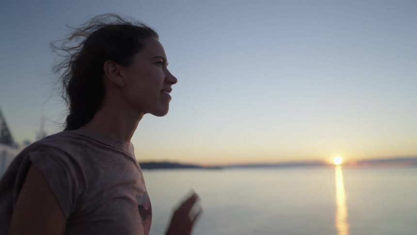 A view of a woman near the edge of the water