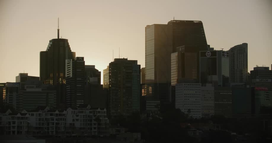 A city skyline with buildings and skyscrapers with the sky and clouds in the background