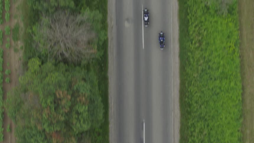 Bikers ride motorcycle on highway in the countryside