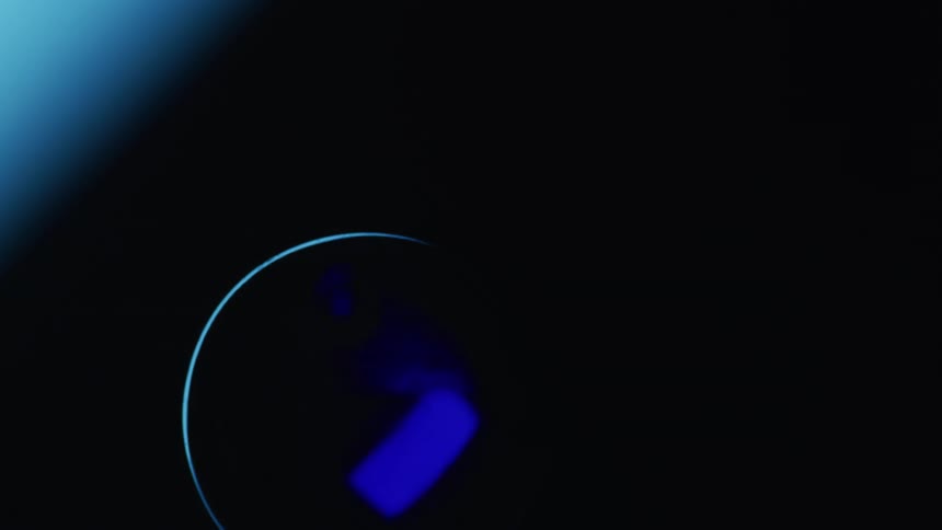 Translucent round shape and surrounding are colored various shades of blue brighten and darken