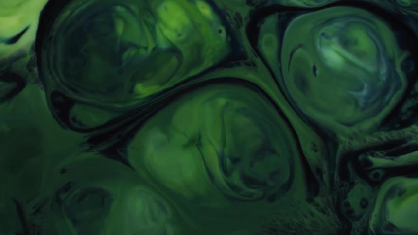 A view of green spheres expanding in liquid