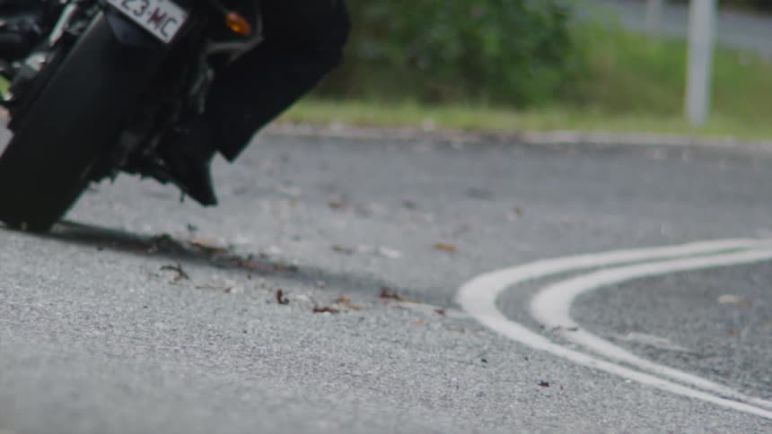 A view of a person riding a motorcycle through a turn