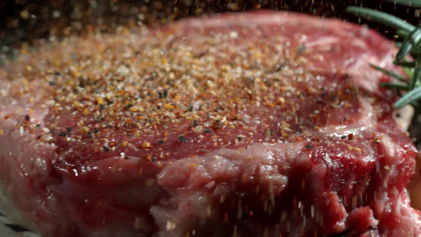 A close up of a steak being prepared