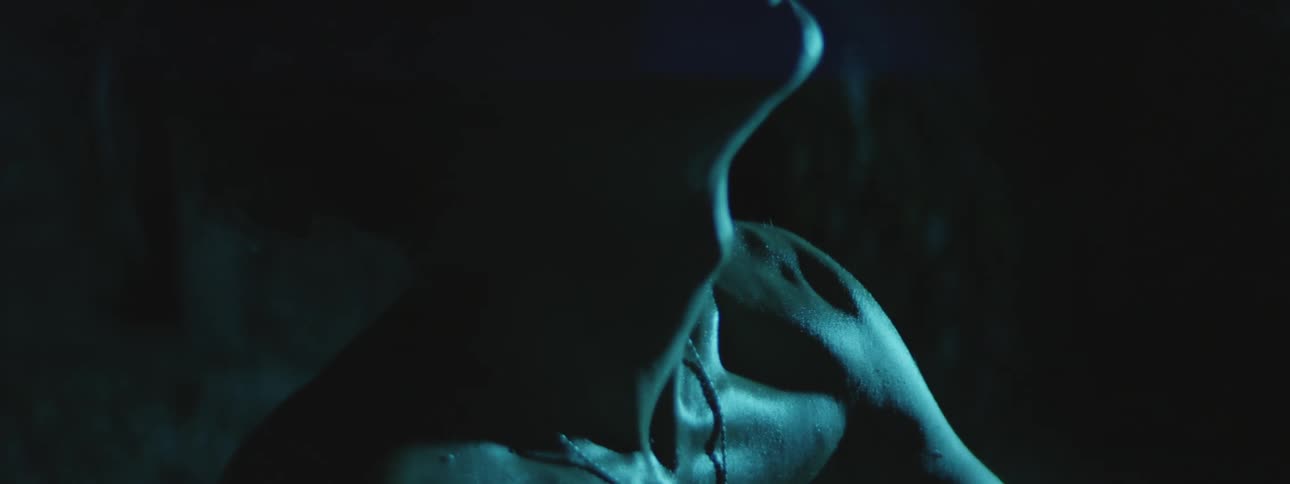 A man is smoking in the dark