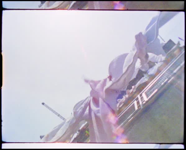 A view of clothes on a line drying outdoors in the wind