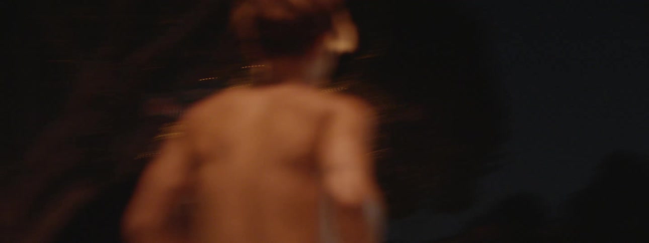A man is running down the street at night