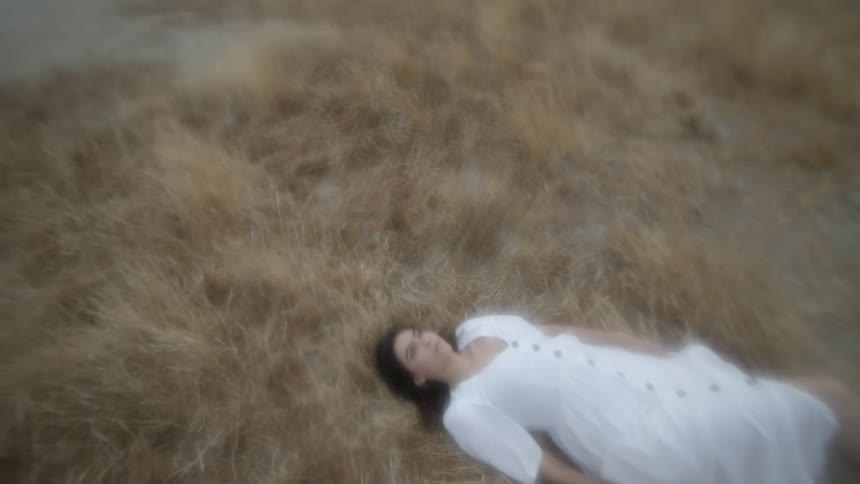 A woman laying in a field resting