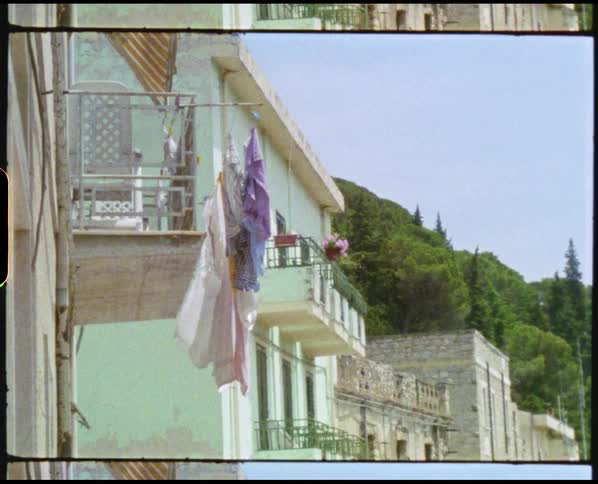 Clothing hangs to dry off an apartment balcony