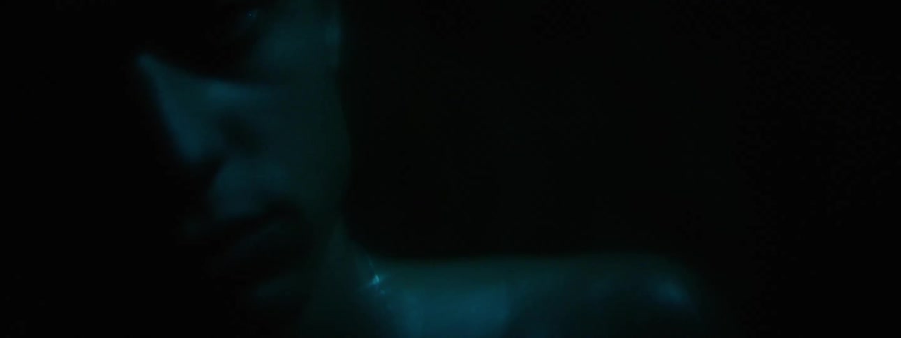 A close up portrait of a man with blue lights on it