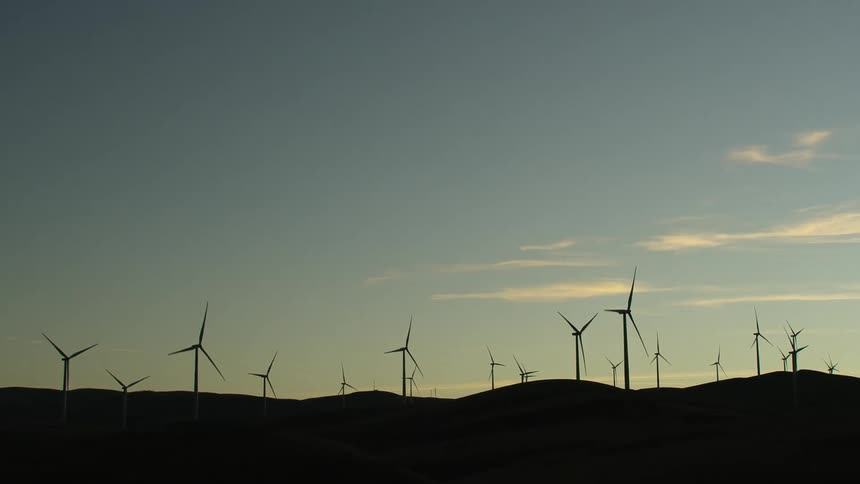 The windmills turn on the hills
