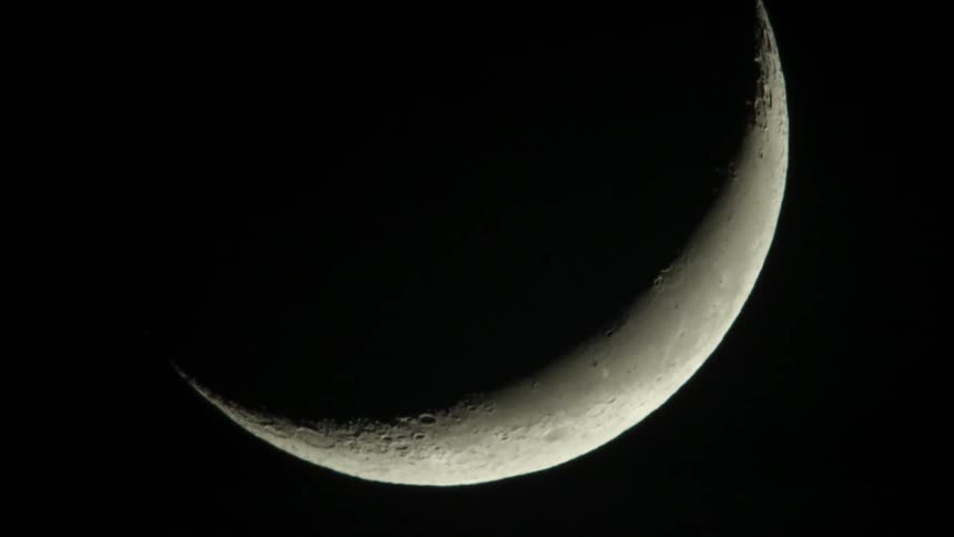 A close up of a crescent moon at night