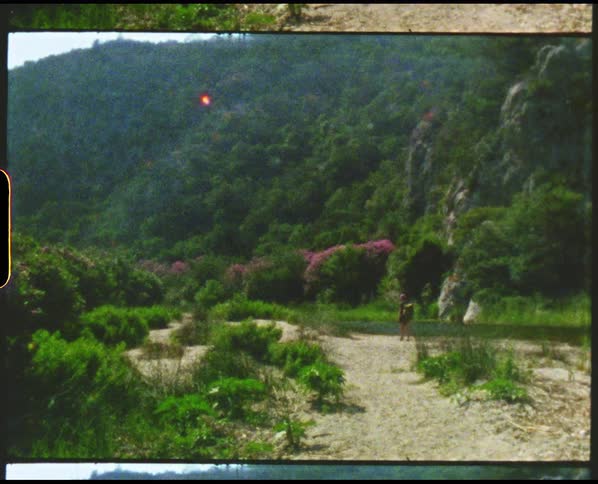 A woman walking around outdoors on a trail