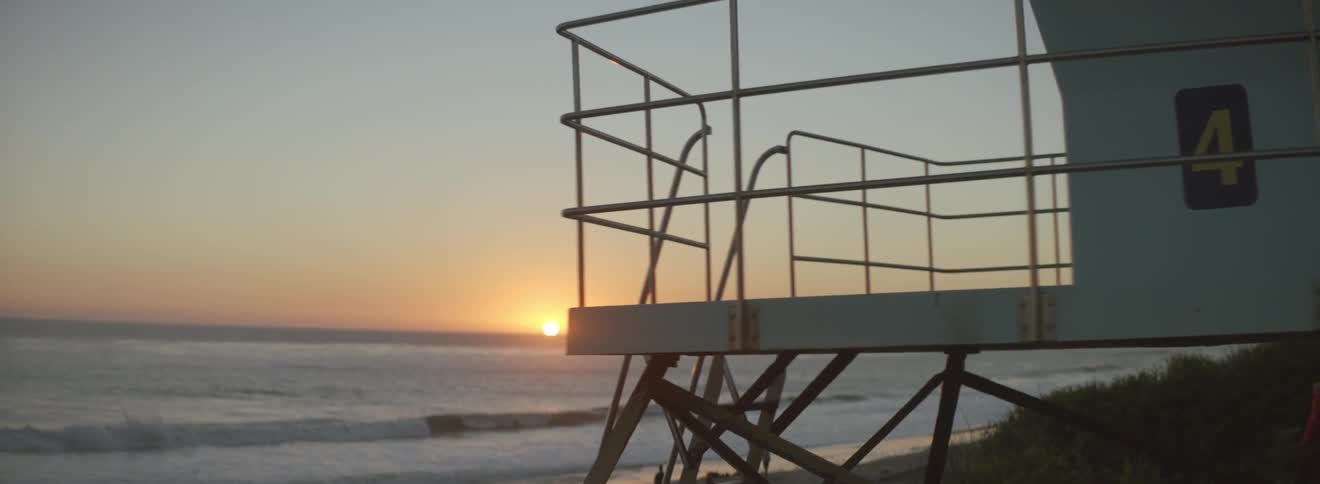 The sun is setting over a beach