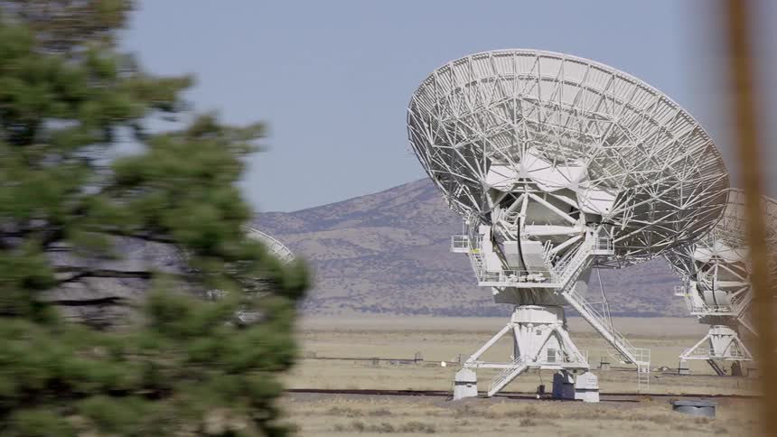 Big radio telescope antenna on the desert near the mountains