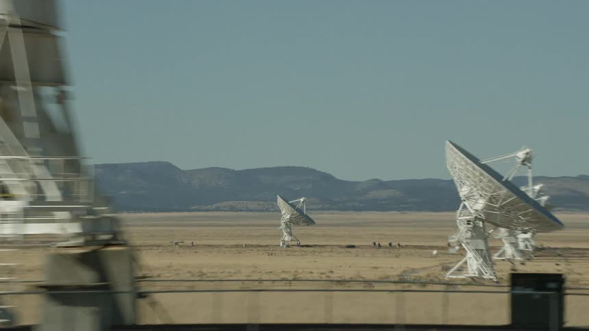 Large satellite dishes cover the desert