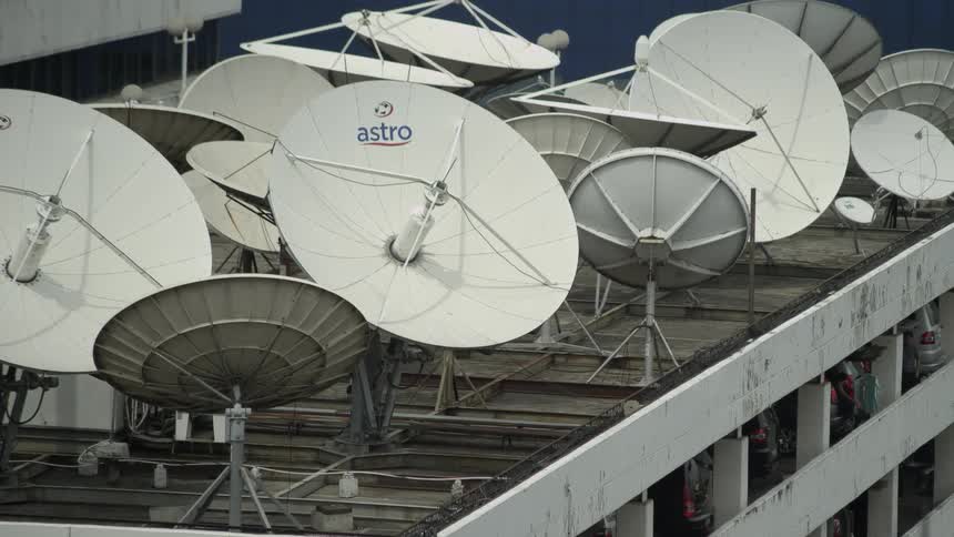 A view of antennas and satellite dishes on a building