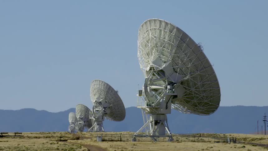 Large dish of radio telescopes on the desert near the mountains