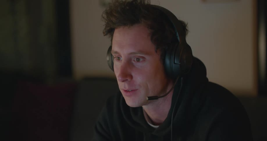 Young sitting on a room talking on a headset at home