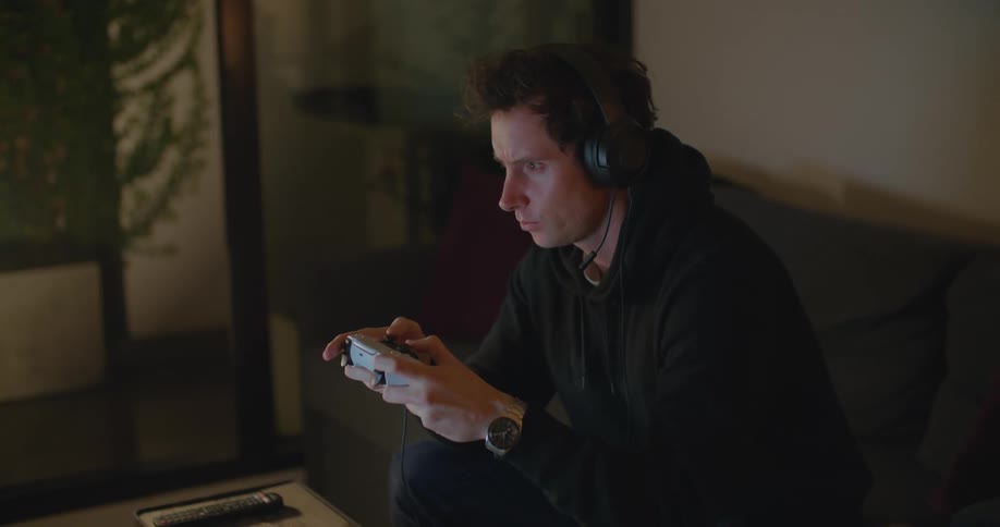 A man playing video games in a house