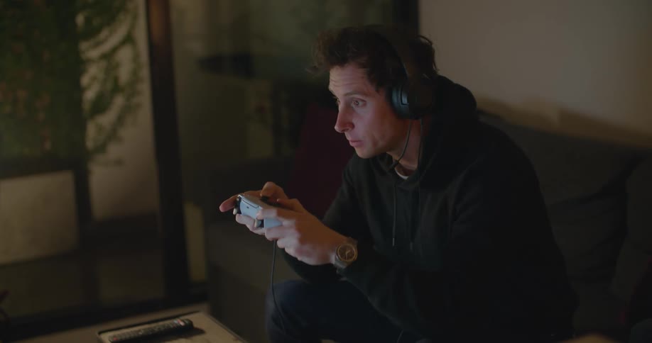 A man playing video games on a couch