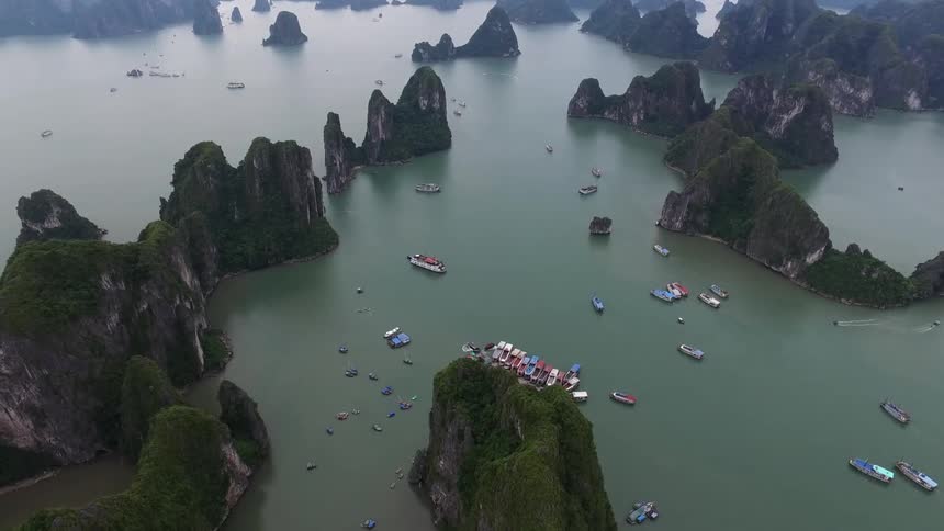 Colorful boats are floating at a dock in a remote ocean bay