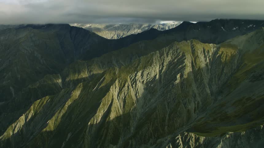 A landscape with cliffs and mountain ranges with the sky and clouds in the background