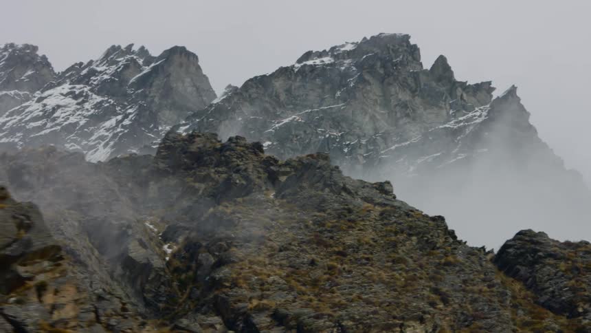 Mountain ridge with snow covered mountains in the distance
