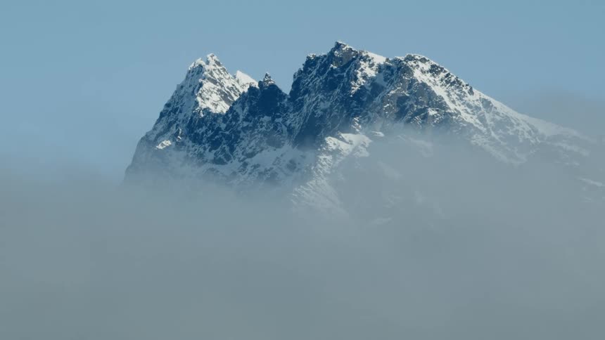 Heavy fog obscures a mountain range