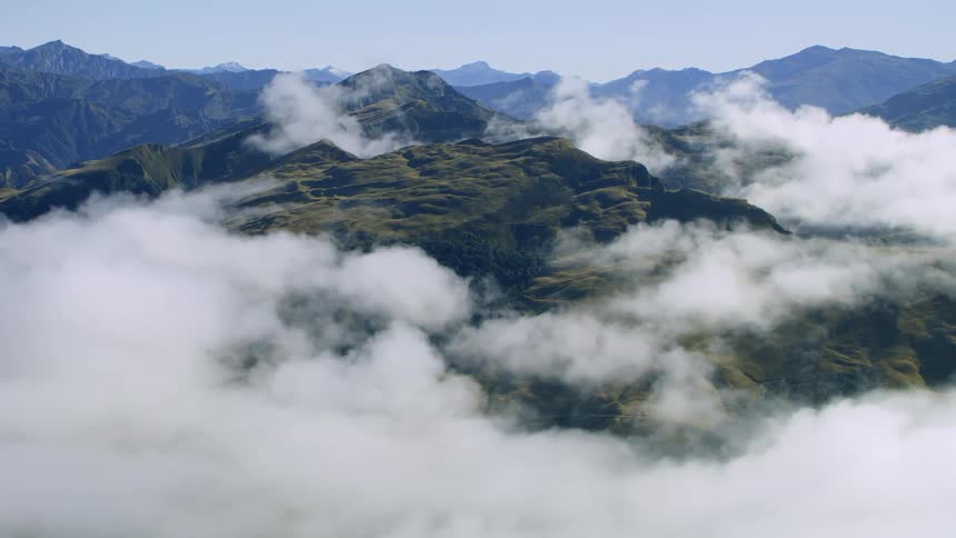 Aerial view of mountains with white clouds around