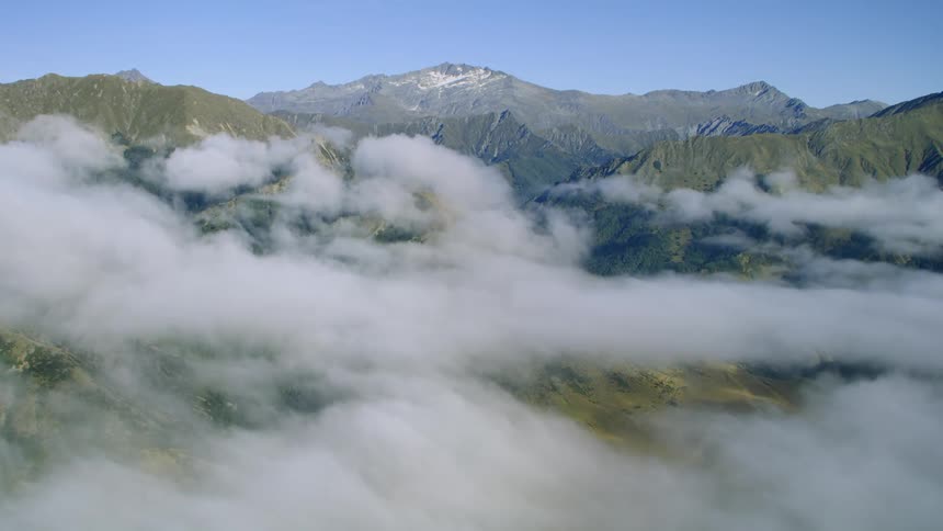 Aerial view of clouds over mountains with blue sky