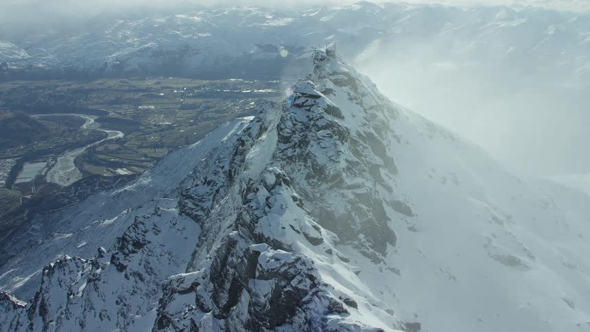 The mountains are covered with snow and mist