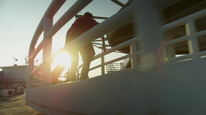 Teenagers are riding their skateboards down the ramp