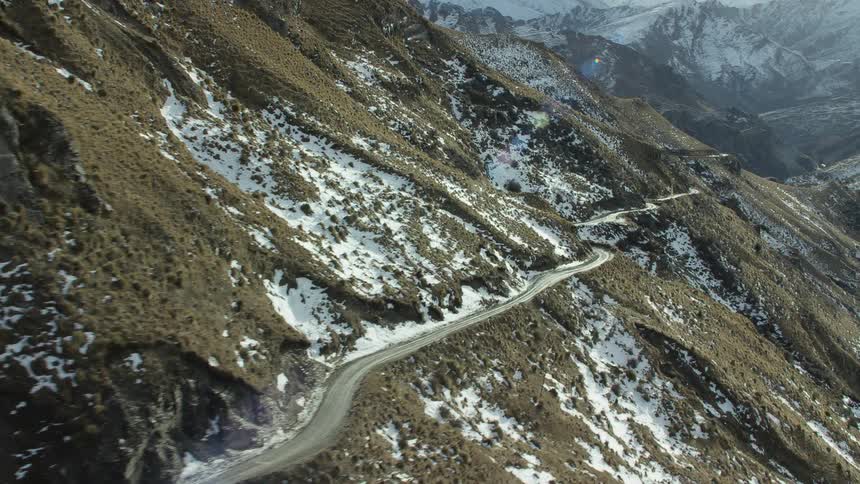 An aerial view of a road on a mountain range