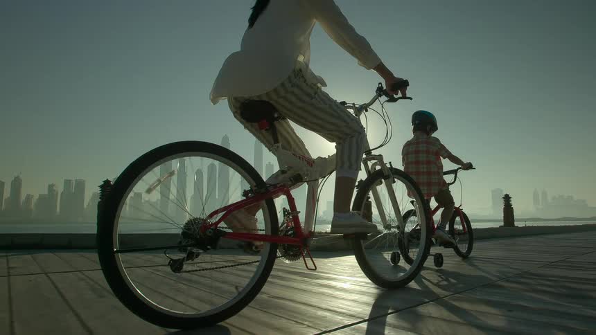 Woman and child biking on a pier