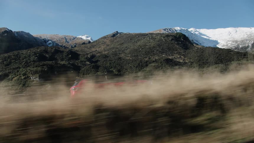 A vehicle driving outdoors on a trail
