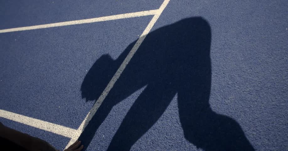 The shadow of a man on a race track
