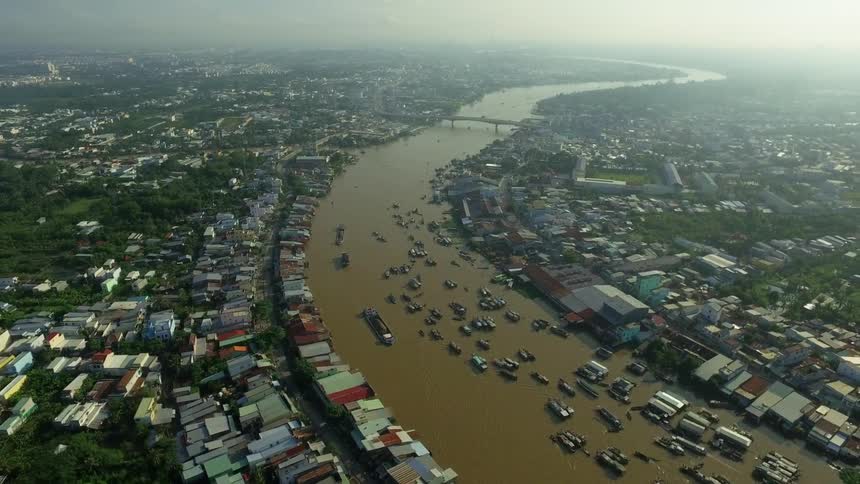The river is filled with boats by the city