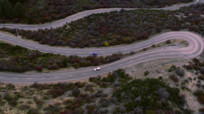 Vehicles travel down a curvy highway