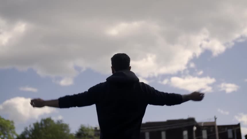 A man is jumping and waving his arms