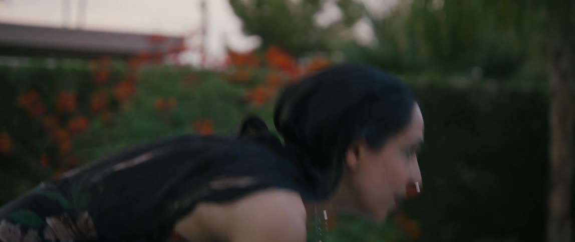 A woman leaving a pool at dusk