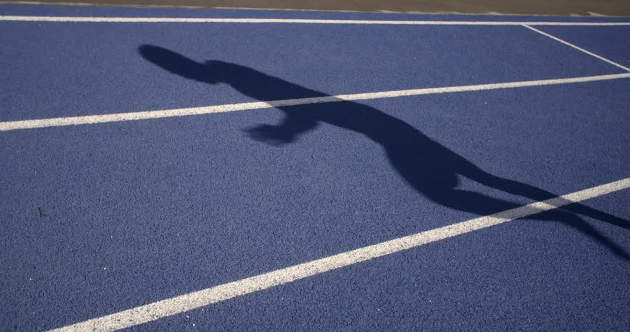 A runner runs down the track