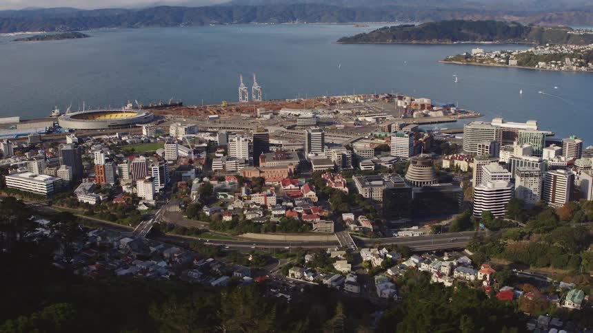 Aerial view of the skyline of a coastal city near the mountains