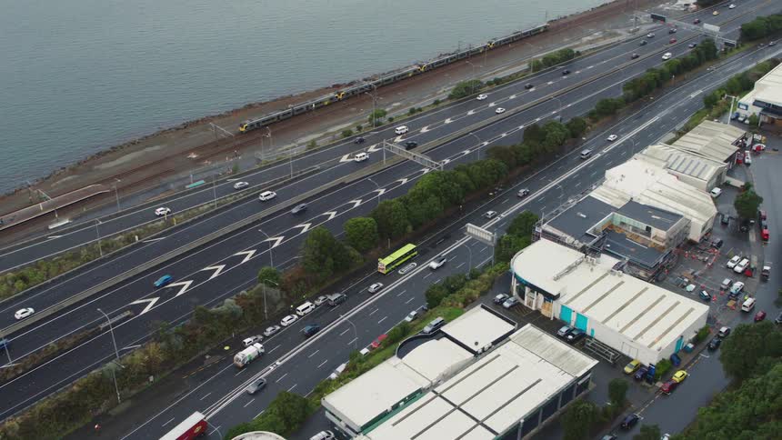 An aerial view of some vehicles driving down a road
